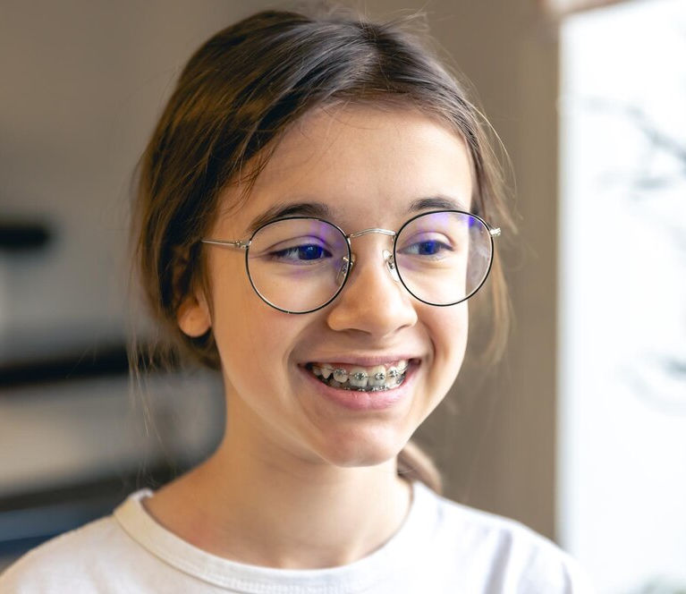 Portrait of a teenage girl with glasses and braces1